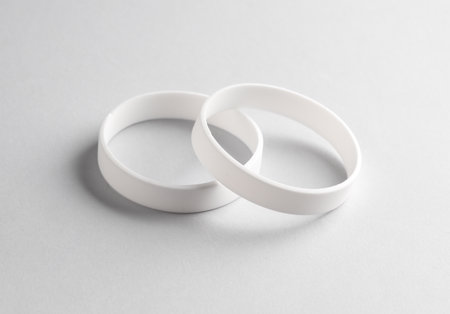 White silicone bracelets on gray background. Template for designの写真素材