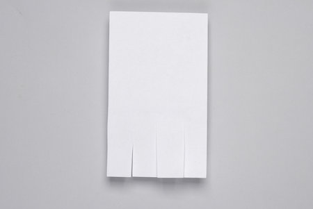 White street paper ad or tear-off stripes with phone number on gray background. template for design.の写真素材