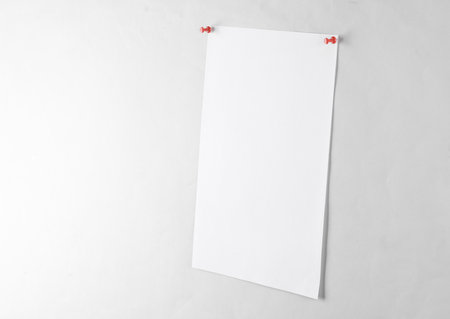 White blank sheet of paper ads pinned on a gray backgroundの写真素材