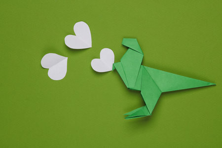 Origami dinosaur with hearts on a blue background. love conceptの写真素材