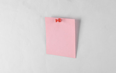 Pink square memo paper pinned on gray backgroundの写真素材