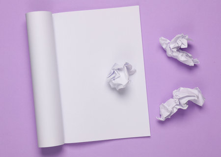 Notebook with torn crumpled sheets of paper on purple backgroundの写真素材