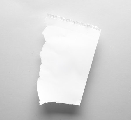 White torn sheet of paper on a gray background. Template for designの写真素材