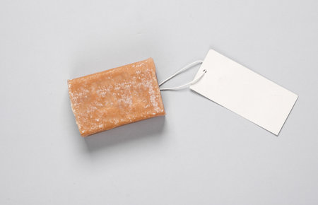 Bar of laundry soap with price tag on gray background. top viewの写真素材