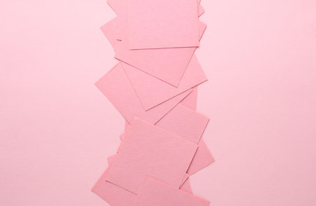 Pink square memo sheet of papers on pink background.の写真素材