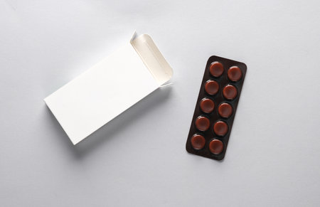 Pill blister mockup with blank cardboard box packaging on gray background. Template for design