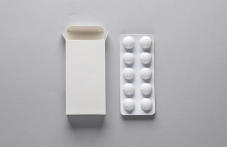 Pill blister mockup with blank cardboard box packaging on gray background. Template for designの写真素材