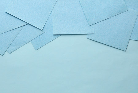 Blue square memo sheet of papers on blue background. copy spaceの写真素材