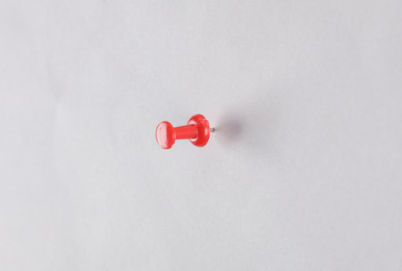 Red push pinned on a gray backgroundの写真素材
