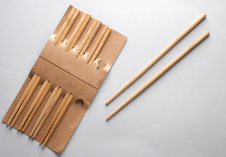 Set of wooden chinese chopsticks on a gray backgroundの写真素材