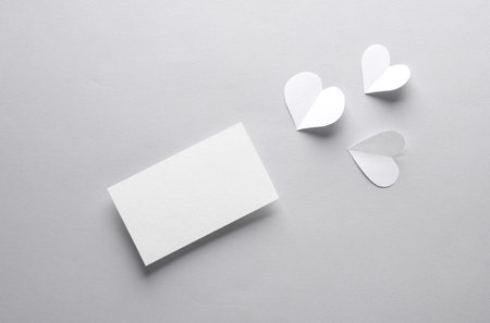 White business card with hearts on a gray background. creative layoutの写真素材