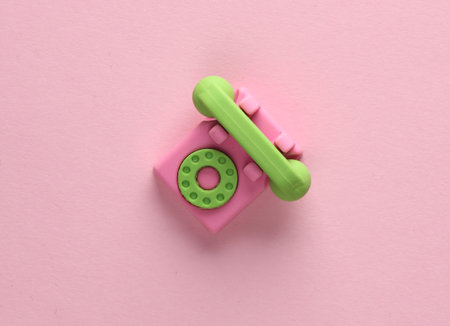 Miniature rotary phone on a pink background. top viewの写真素材