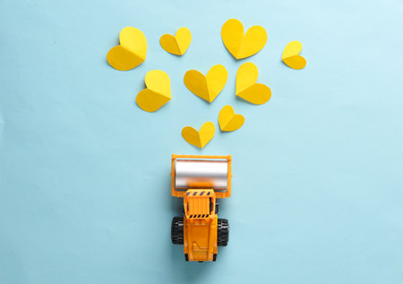 Miniature paver with yellow hearts on a blue background. top view