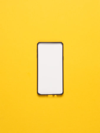 Black silicone case for a smartphone with a white tab on a yellow background