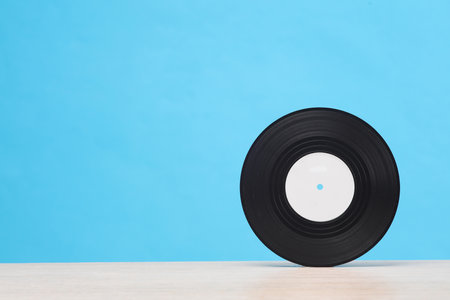 Vinyl record on the table, blue backgroundの写真素材