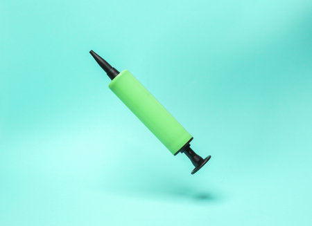 Balloon pump levitating on a blue backgroundの写真素材