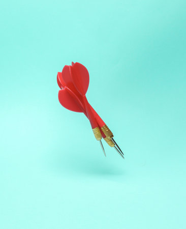 Red darts needles levitating on a blue backgroundの写真素材