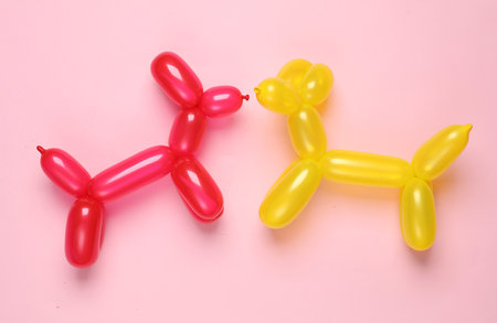 Two balloon dogs on a pink backgroundの写真素材