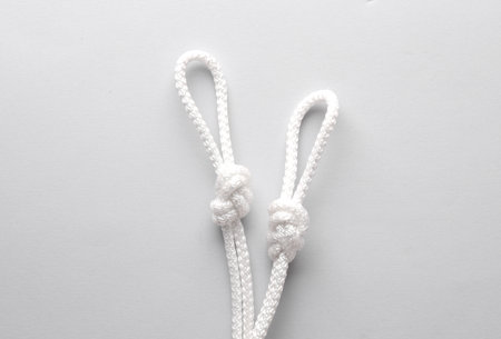 Rope with a knots and loops on gray backgroundの写真素材