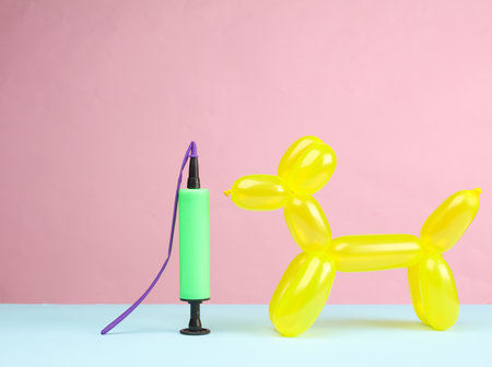 Pump and dog balloon on pink blue background. birthday partyの写真素材
