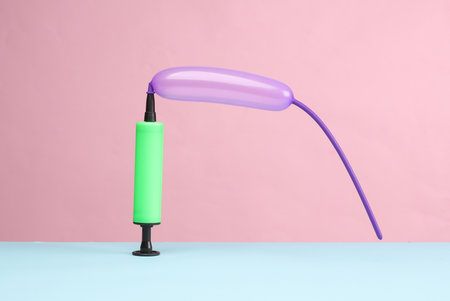 Balloon with pump on blue pink background. birthday party funの写真素材