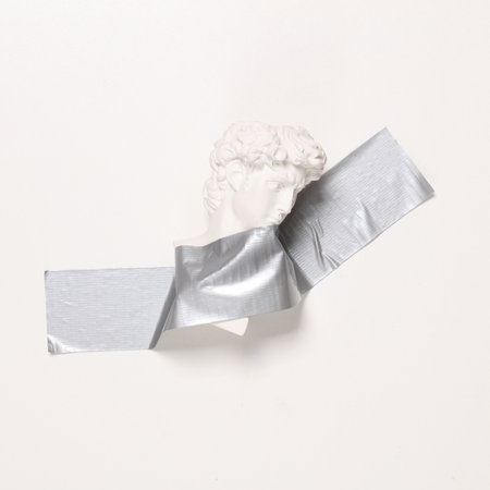 David bust fixed with adhesive tape on white background. Conceptual pop, contemporary art, minimalist still lifeの写真素材