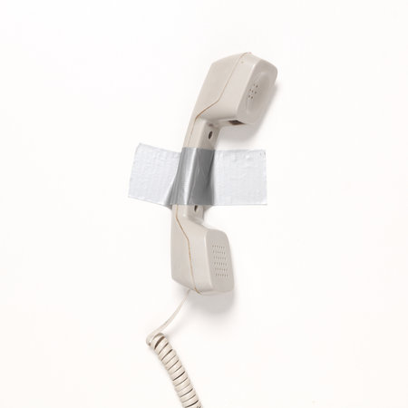 Retro phone tube fixed with adhesive tape on white background. Conceptual pop, contemporary art