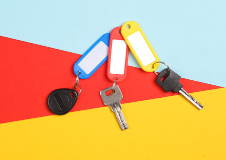 Plastic tags with different keys on colored backgroundの写真素材