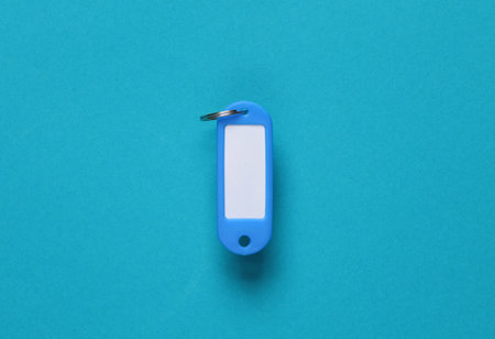 Plastic key tag on blue background