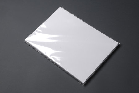 A4 papers in cellophane packaging on a dark background