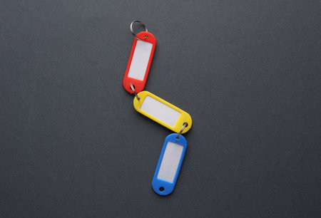 Plastic key tags on dark gray backgroundの写真素材