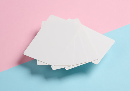 Stack of white blank bank card on pink blue background. Template for design