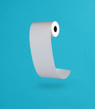 Roll of cash register tape levitation on blue background with shadowの写真素材
