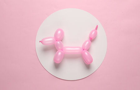 Inflatable balloon dog on in white circle on pink background. Creative layoutの写真素材