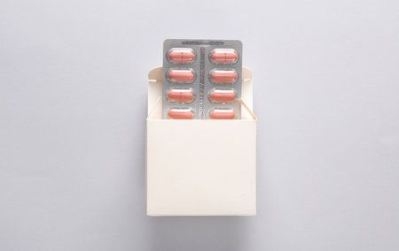 White box mockup with blister pills on gray background. Template for design