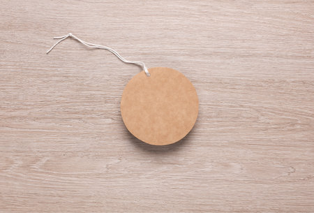 Round craft sale tag with string on the tableの写真素材
