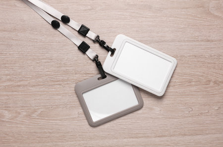 Blank id cards badges on a strap, lies on the table