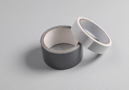 Different rolls of duct tapes on gray backgroundの写真素材
