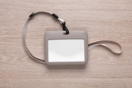 Blank id card badge on a strap, lies on the tableの写真素材