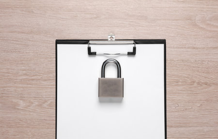 top secret. clipboard with padlock on tableの写真素材
