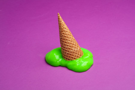 Waffle cone with green slime on a purple background. minimal halloween layoutの写真素材
