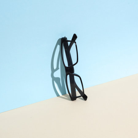 Eyeglasses on blue beige background. creative layout