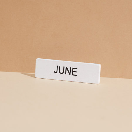 White plate with the month of June on beige background. creative layoutの写真素材