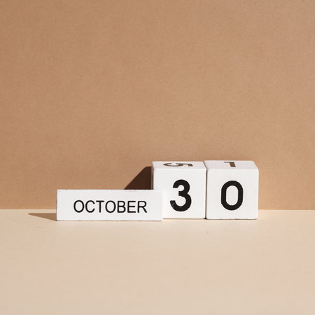 Wooden white block calendar with date october 30 on beige background with shadow. Creative layout, planning, holidaysの写真素材