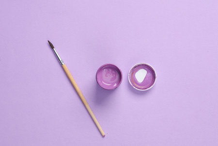 Jar of lavender color paint with a brushの写真素材