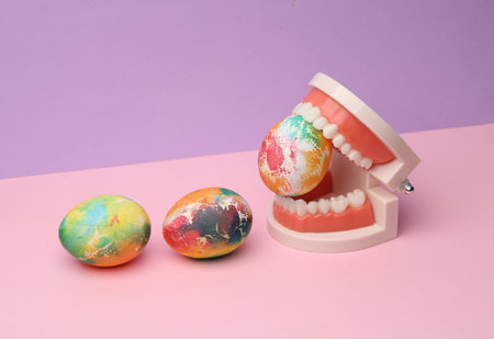 Easter colored eggs in jaw on pastel color background. Minimalism Easter still life