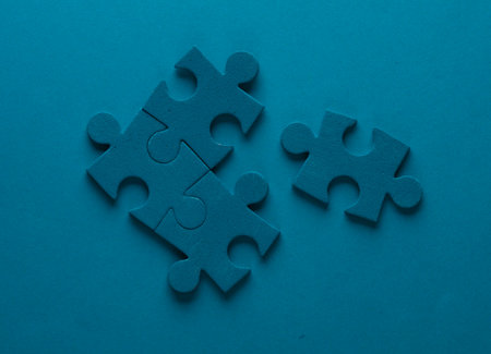 Blue jigsaw puzzle particles on blue background. Business conceptの写真素材