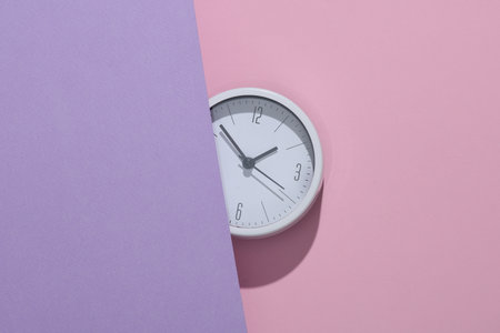 Half clock on a pastel background. Creative layout