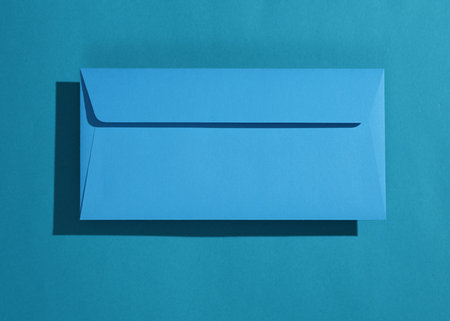 Rectangular blue envelope on blue backgroundの写真素材