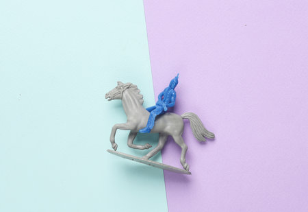 Toy Indian American soldier on horse, pastel background. Wild west, westernの写真素材